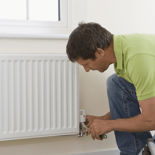 Handyman fixing radiator