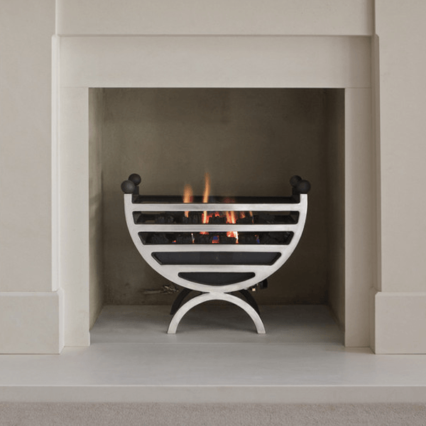 a large marble fireplace in an expensive new home featuring a modern gas fire cradle. The fire is turned on