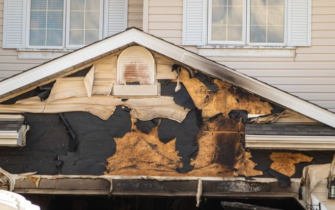 The front of a house that has been damaged by a fire.