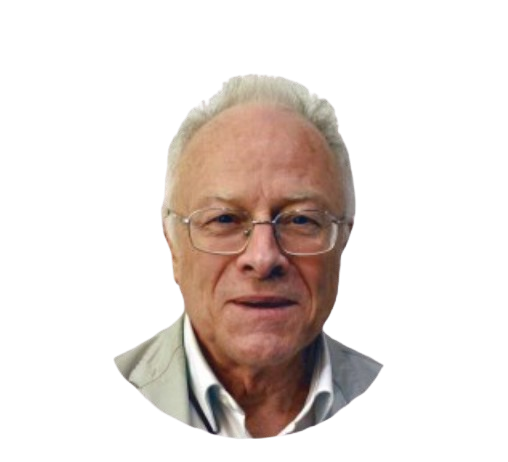 Un homme portant des lunettes, des cheveux clairs et une chemise blanche regarde droit devant lui.