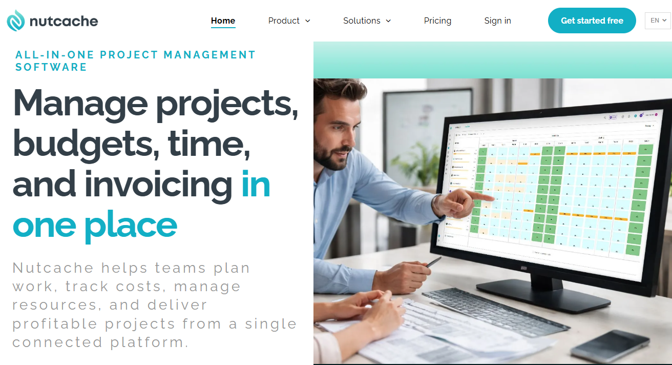 A man points to a computer monitor displaying project management software on the Nutcache website.