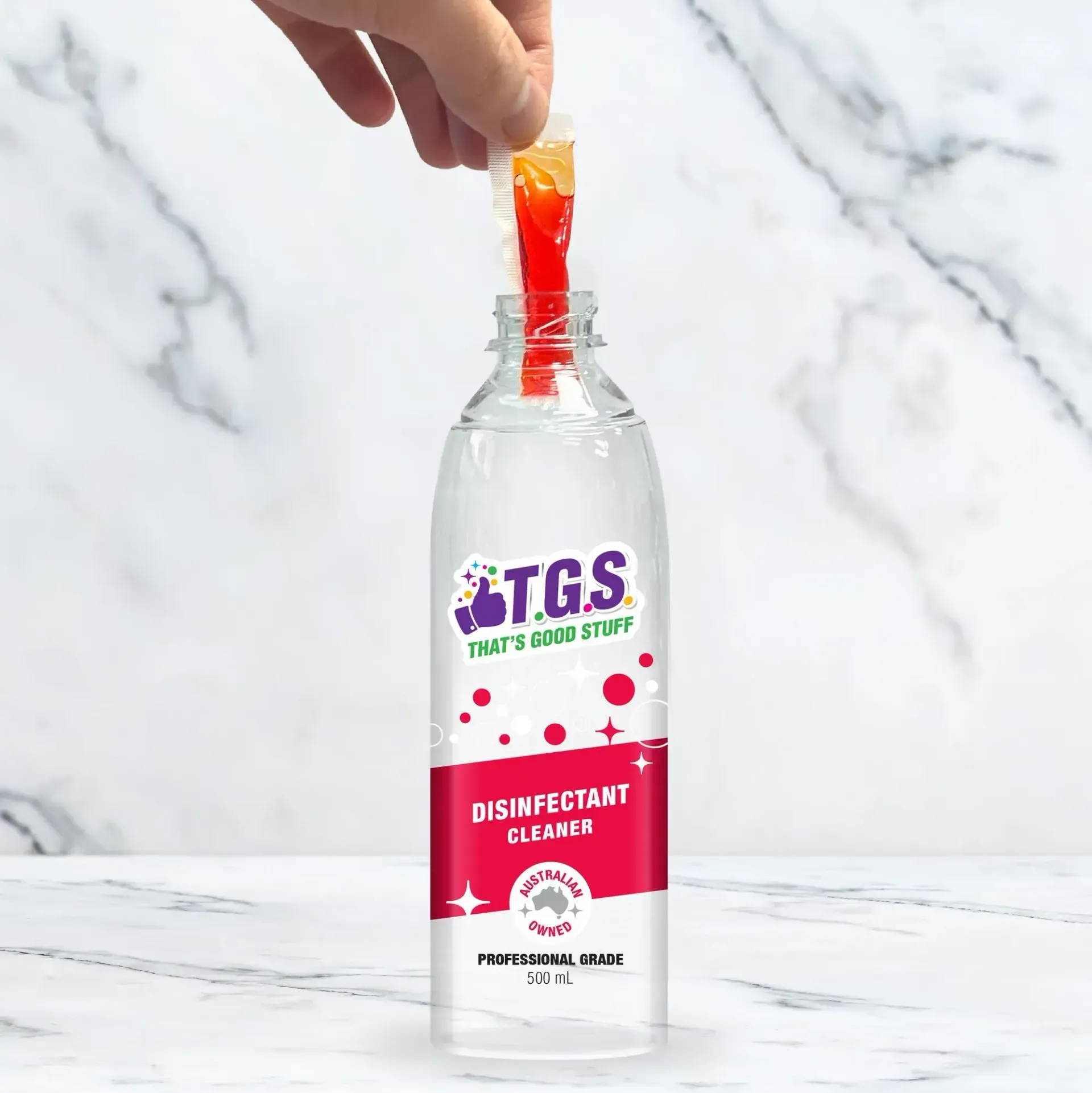 A bottle of tgs disinfectant cleaner is being poured into a tube