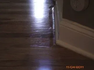 a light is shining on a wooden floor in a room
