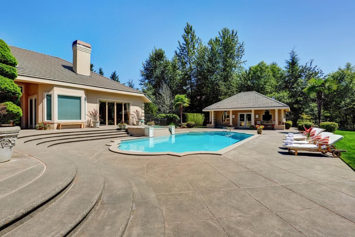 A large house with a large swimming pool in the backyard.