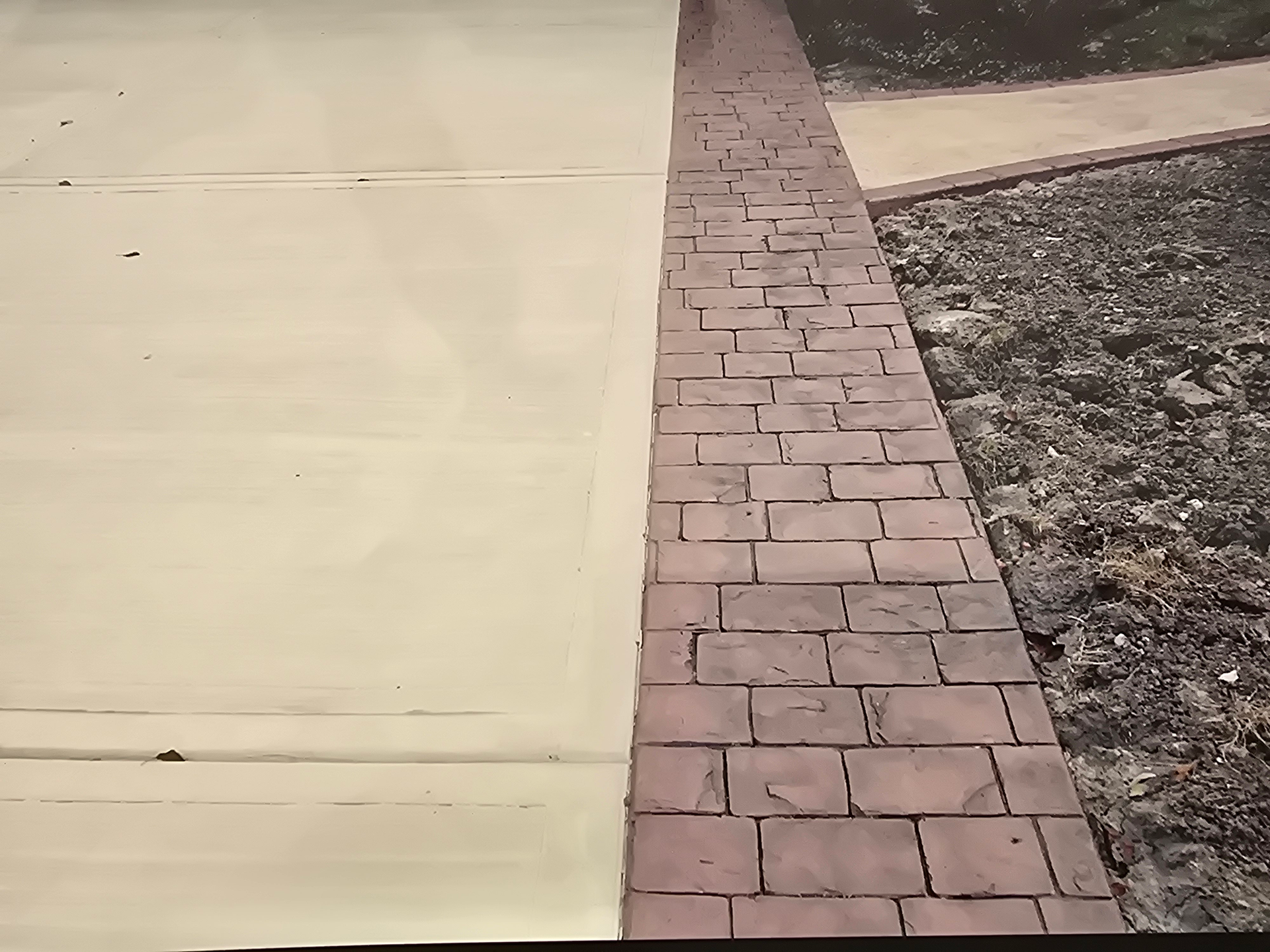 A person is spraying foam on a concrete floor.