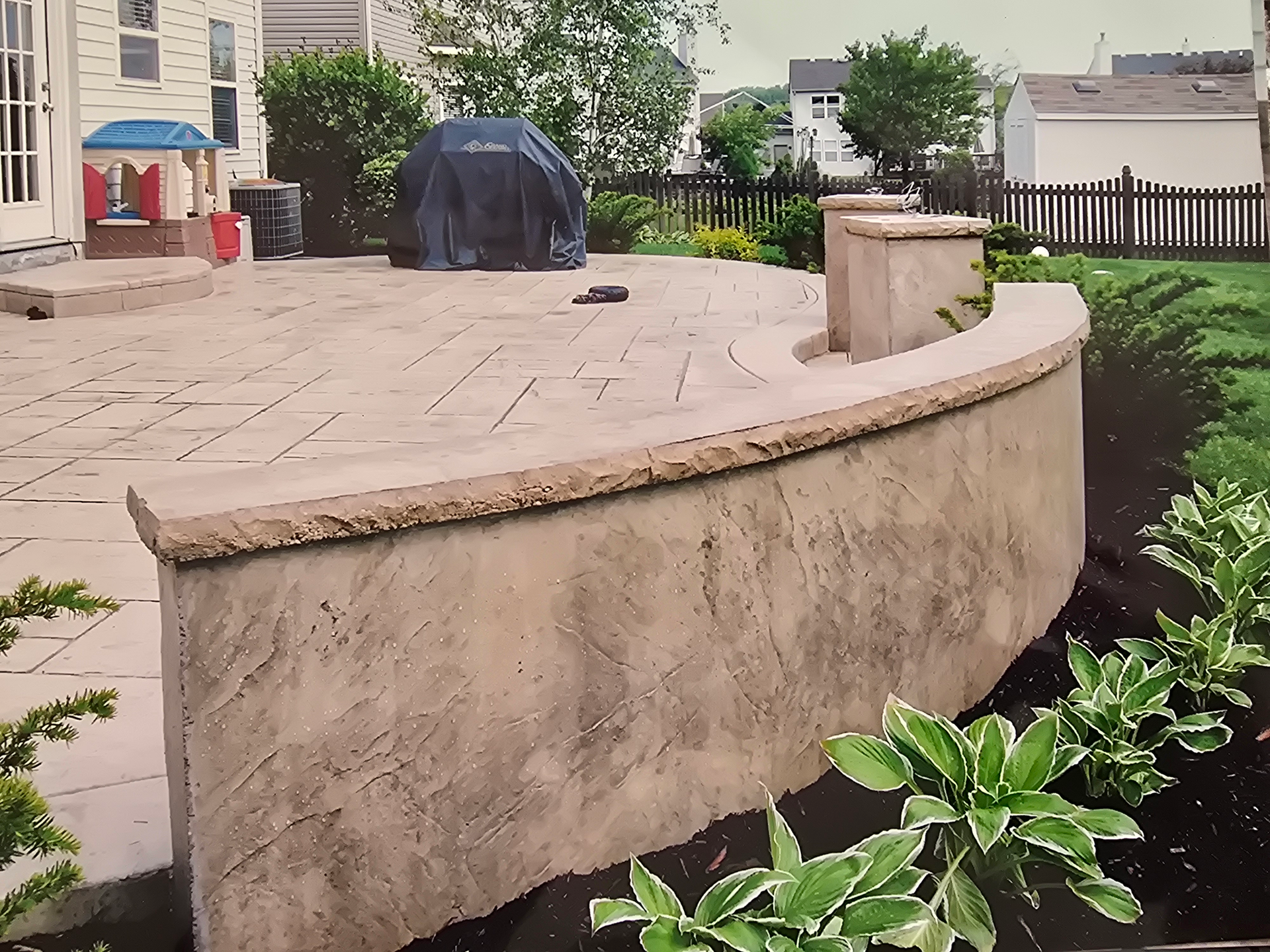 A patio with a chair and a potted plant.
