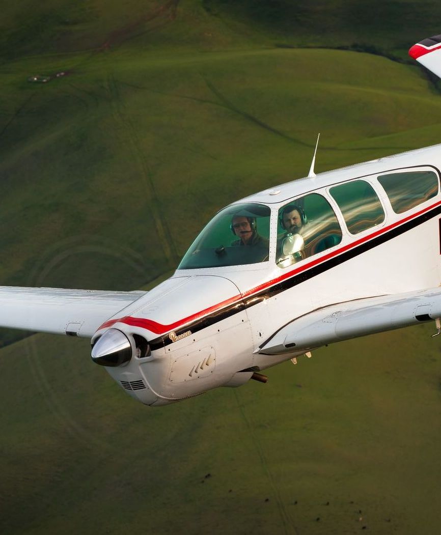 A close up of an airplane engine in a hangar.