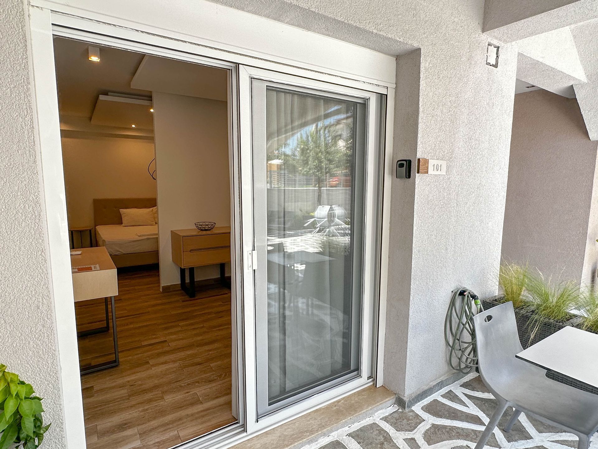Sliding glass door with screen leading from interior room to patio.