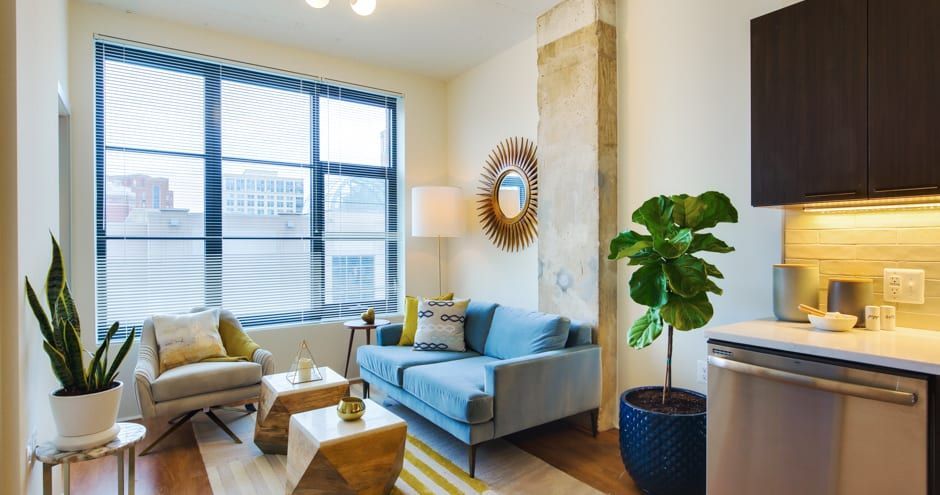 Apartment living room with oversized windows at The Foundry.