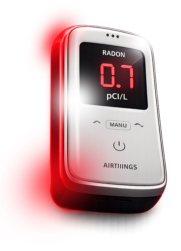 White and black Radon detector with red digital display reading 0.7 pCi/L
