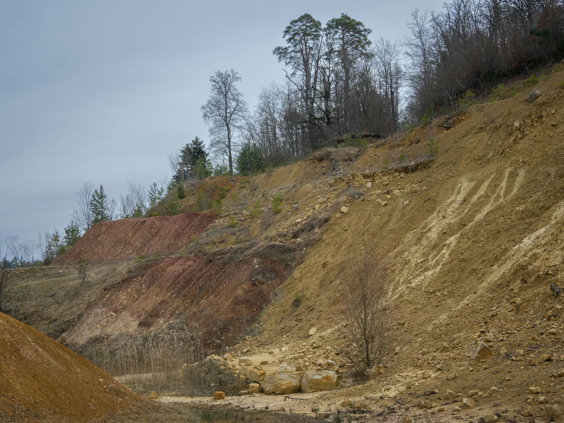 A white semi-truck pulls a large, single-story stone house down a dark residential street at night.