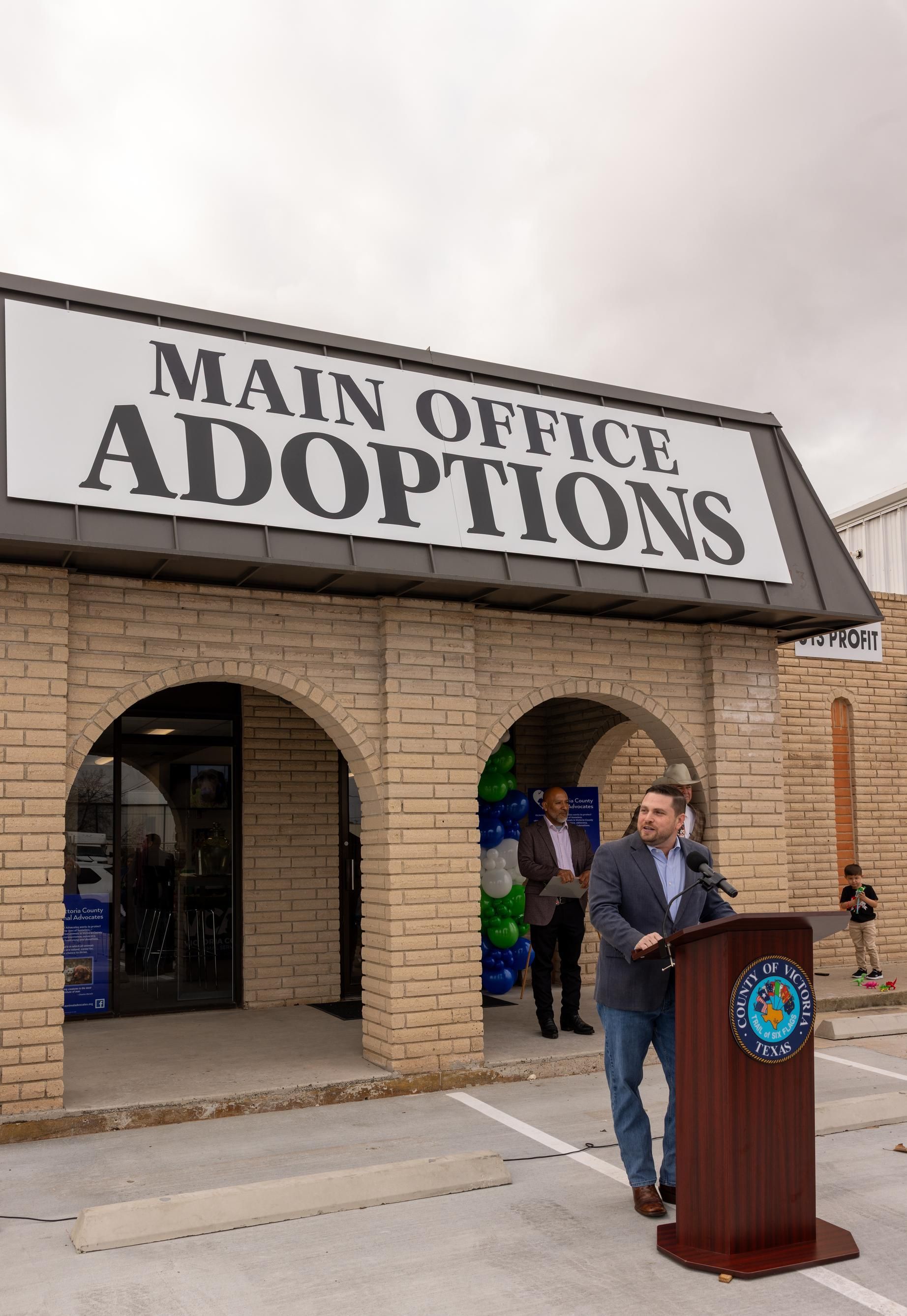 Man speaking at podium outside 