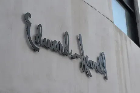 Edward Hayes name sign on a light-colored building wall.