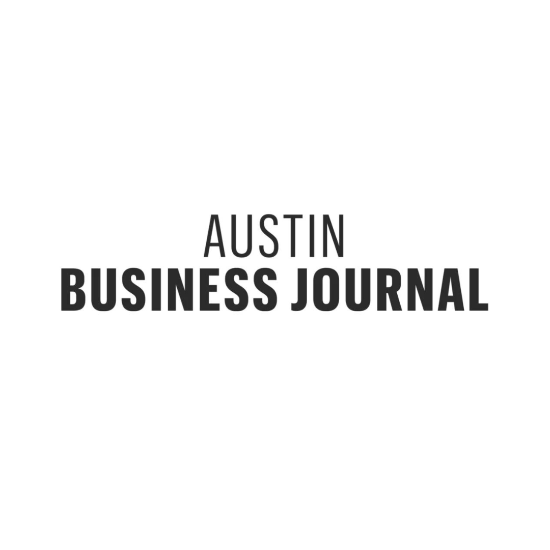 The logo for the austin business journal is black and white.