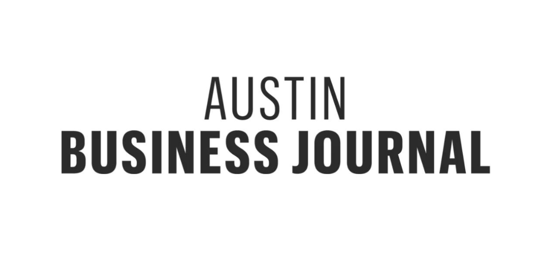 The logo for the austin business journal is black and white.