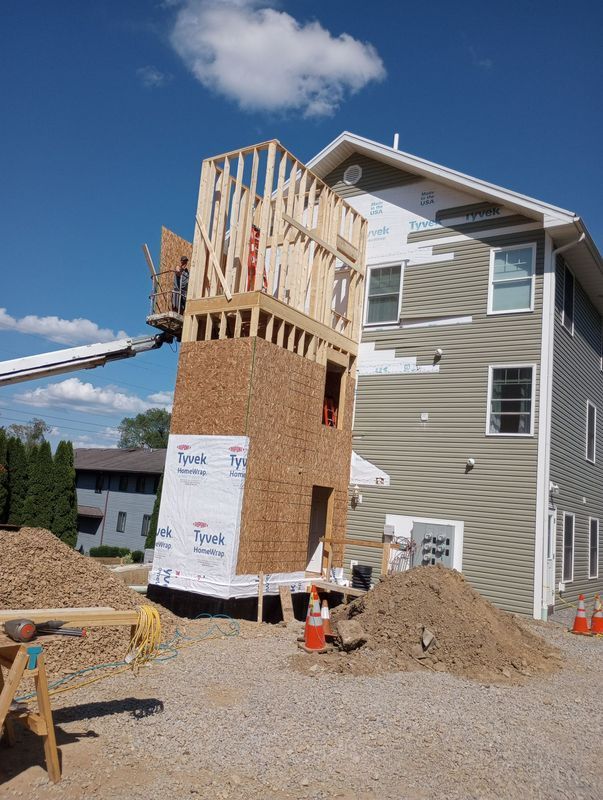 A house that is being built with a crane on top of it