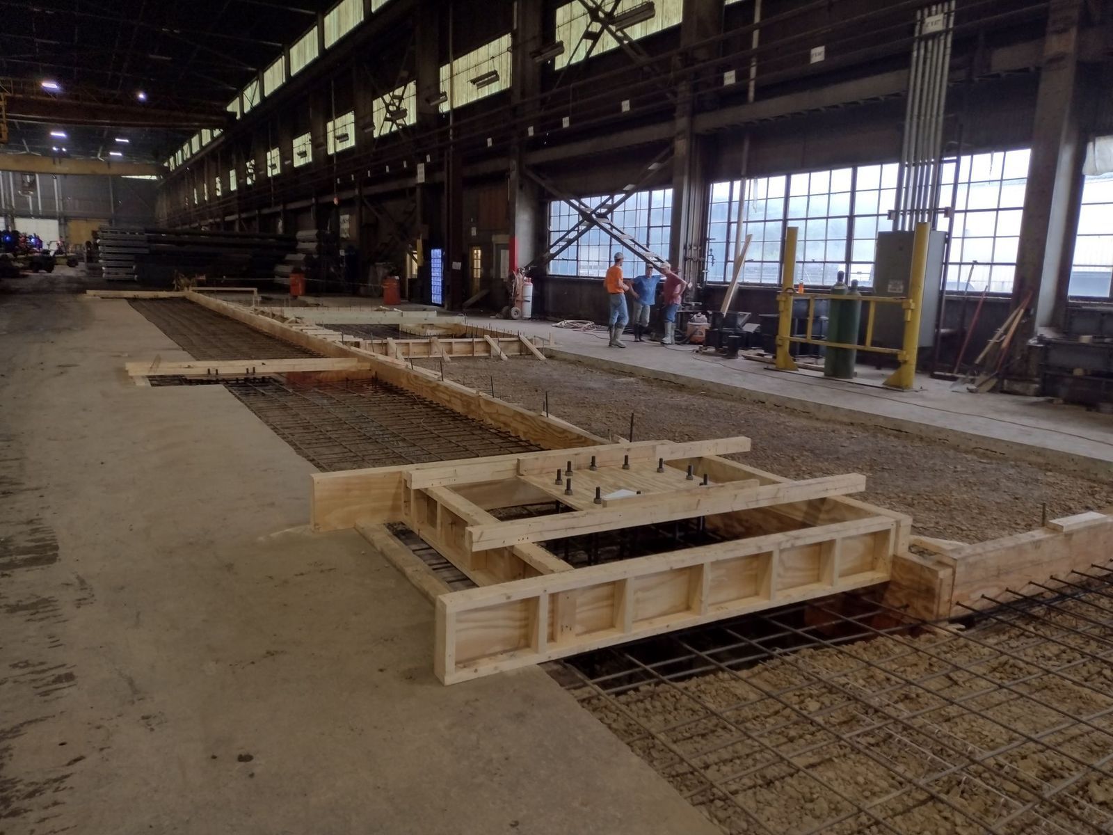 A large building with a lot of windows and a concrete floor.