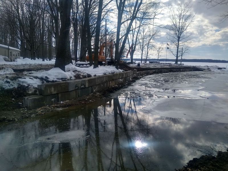 A large body of water with trees in the background