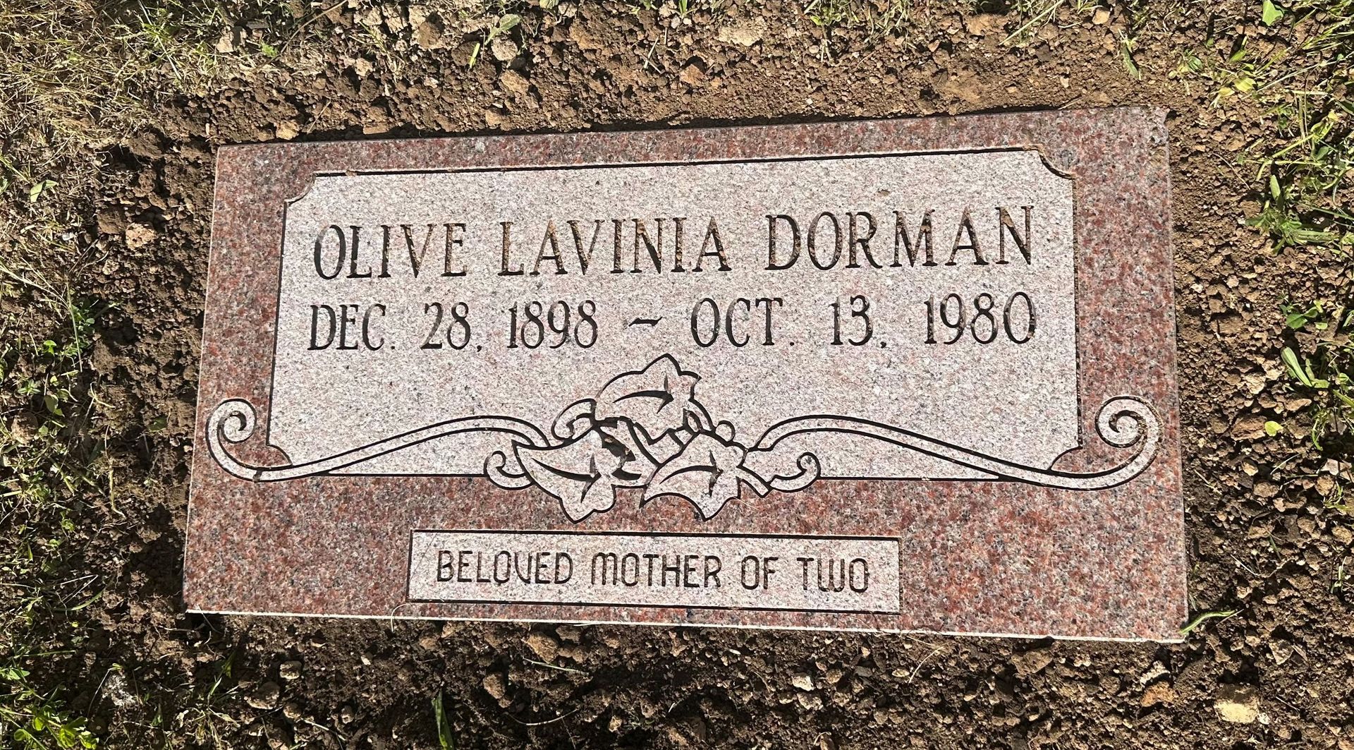 A gravestone for olive lavinia dorman in a cemetery.