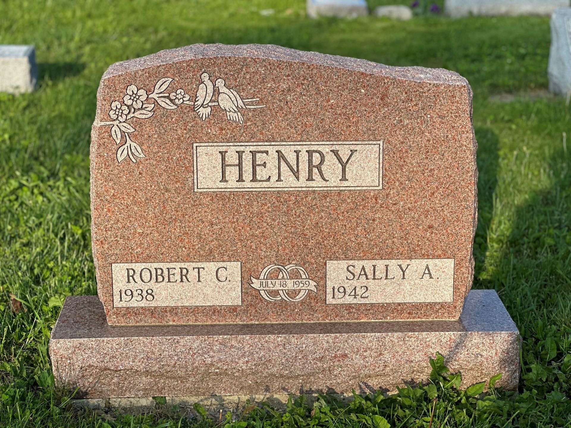A gravestone in a cemetery with the name henry on it.