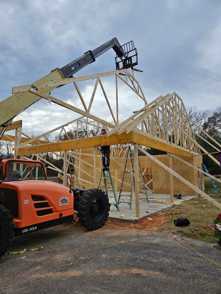 A gutter with leaves coming out of it and a roof in the background.