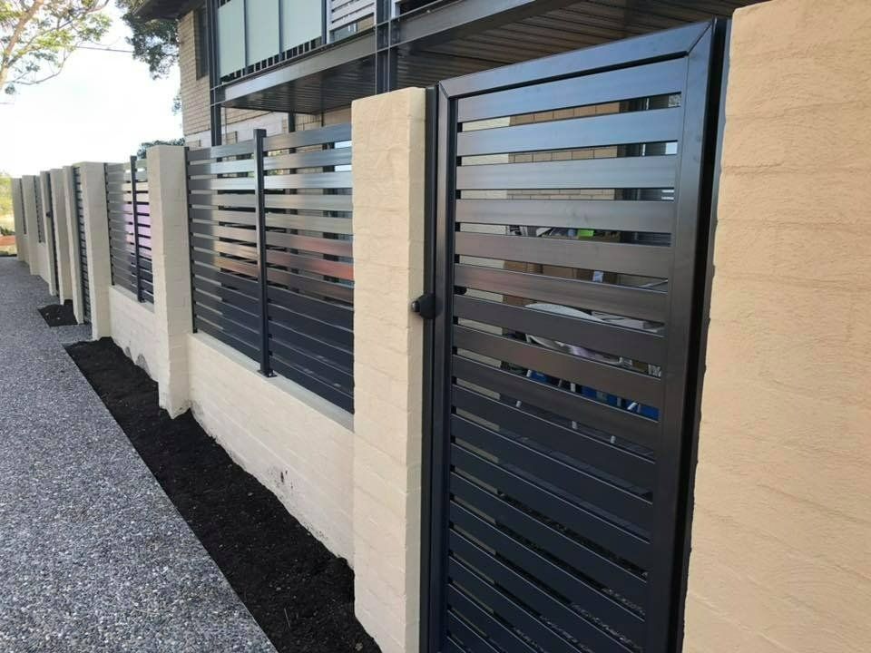 A Black Fence with A Gate in Front of A Building — Oz-Craft in Taree, NSW