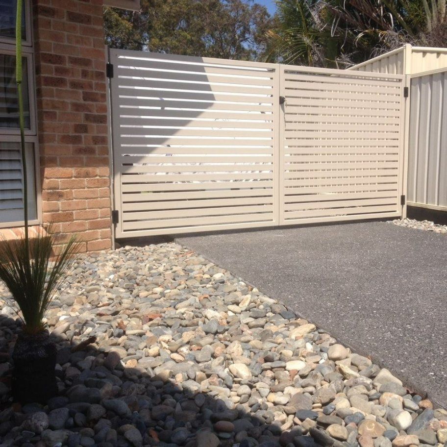 A White Fence with A Brick Building — Oz-Craft in Forster, NSW