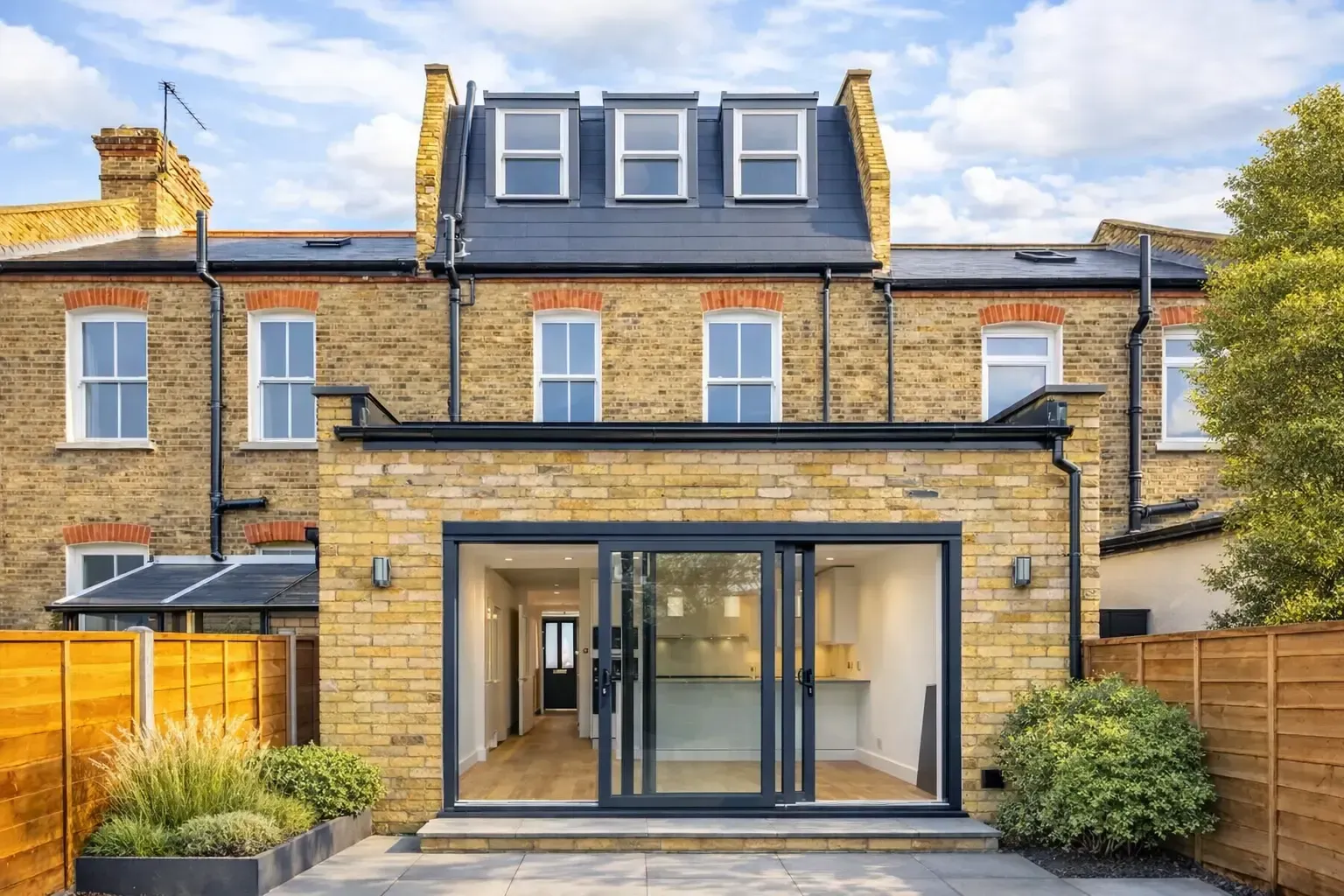 Open plan kitchen and living space created through full house refurbishment, 4‑metre rear extension and loft conversion in Raynes Park SW20 – CSarchitects