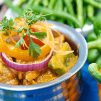 There is a bowl of food with vegetables in it.