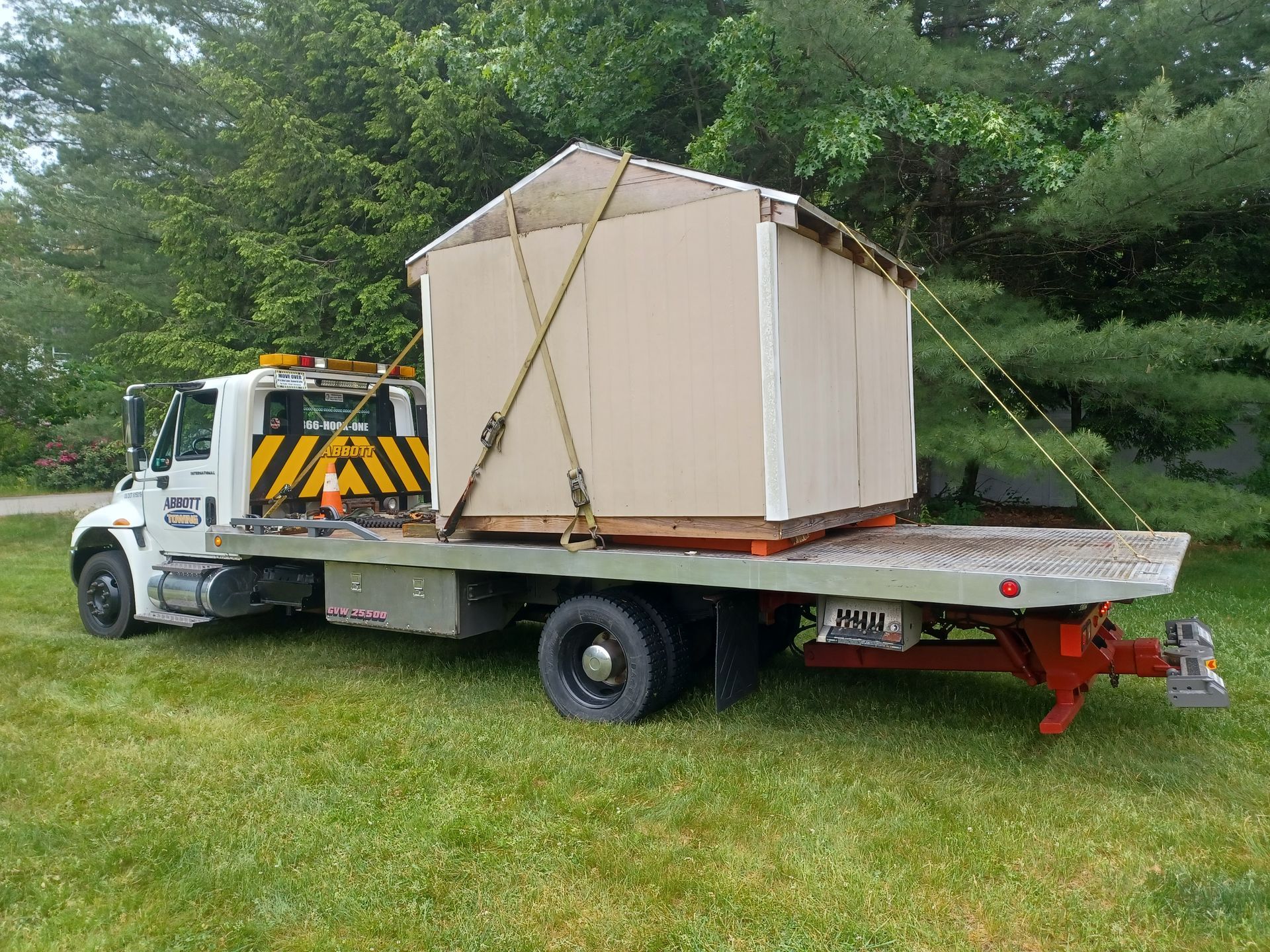A Truck Carrying a Shed Parked Under the Tree — Hudson, NH — Abbott Towing Service