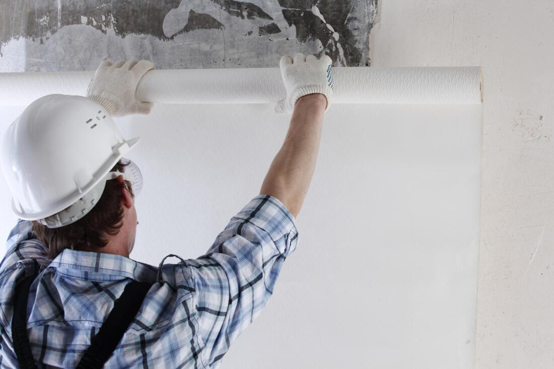 worker removing wallpaper in Orange County, CA