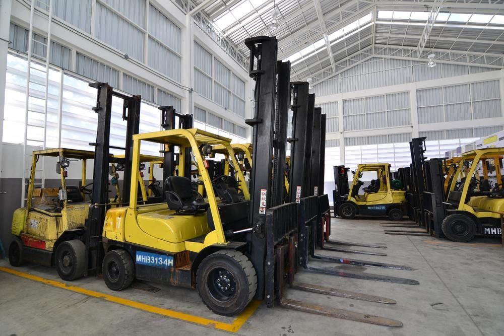 Row of Forklifts Are Parked in a Warehouse — Bundaberg Forklift Repairs Mundubbera, QLD