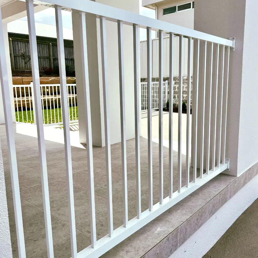 A White Railing Is Sitting On The Side Of A BuildING — Mid Coast Glass Fencing In Laurieton, NSW