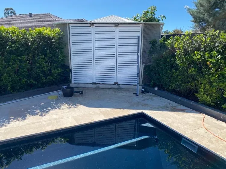 A Swimming Pool With A White Fence Surrounding IT — Mid Coast Glass Fencing In Forster, NSW
