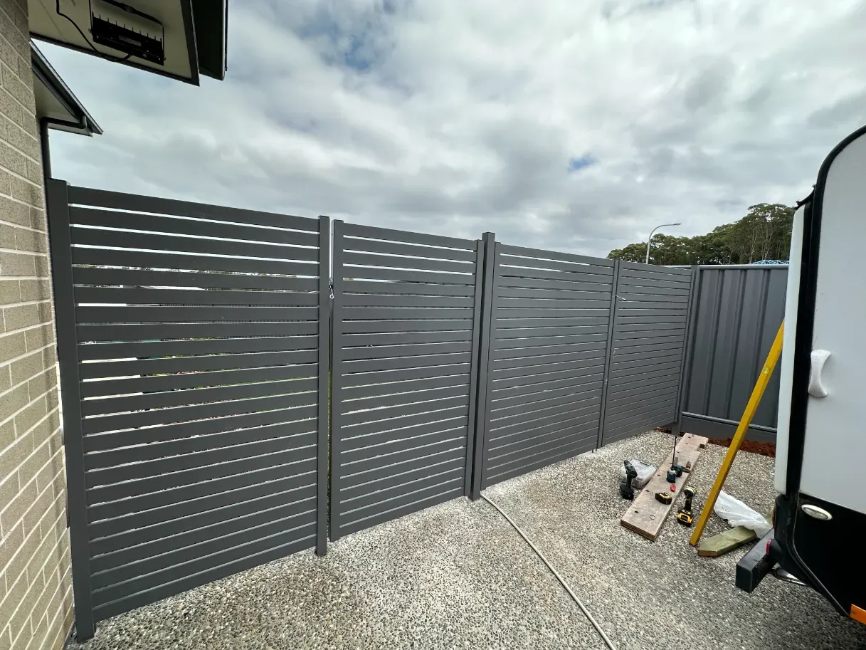 A Fence Is Being Built In The Backyard Of A HoUSE — Mid Coast Glass Fencing In Forster, NSW