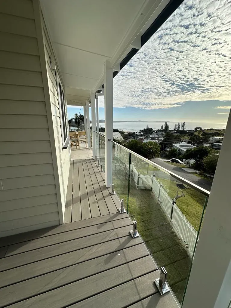 A Balcony With A Glass Railing And A View Of The OcEAN — Mid Coast Glass Fencing In Hallidays Point, NSW