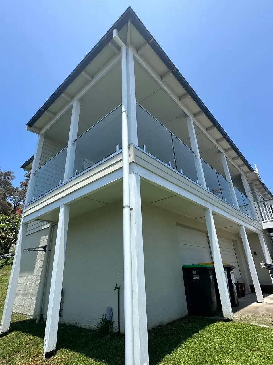 A White House With A Balcony And A Blue Sky In The BackgroUND — Mid Coast Glass Fencing In Taree, NSW