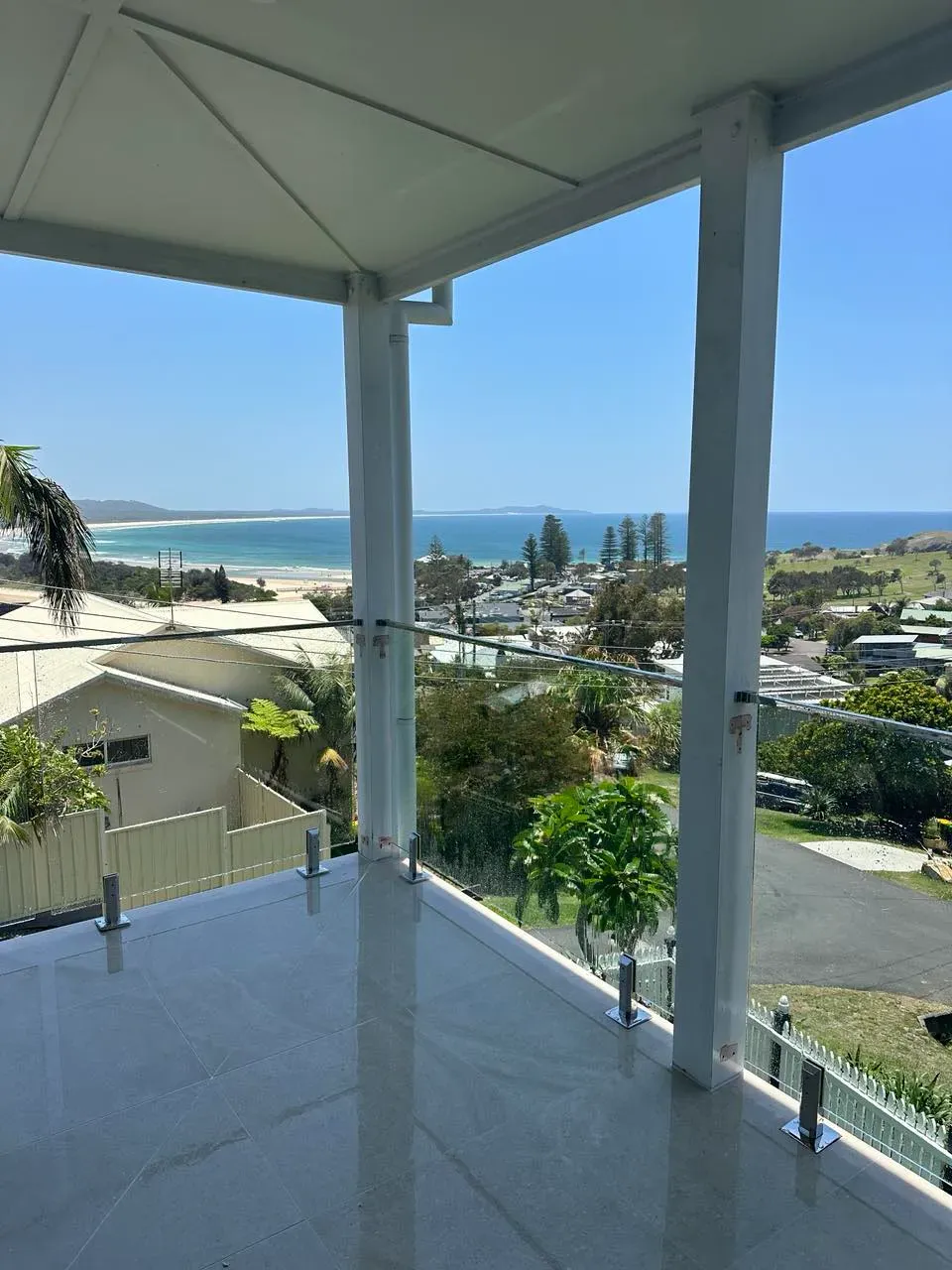 A Balcony With A View Of The Ocean And A CITY — Mid Coast Glass Fencing In Port Macquarie, NSW