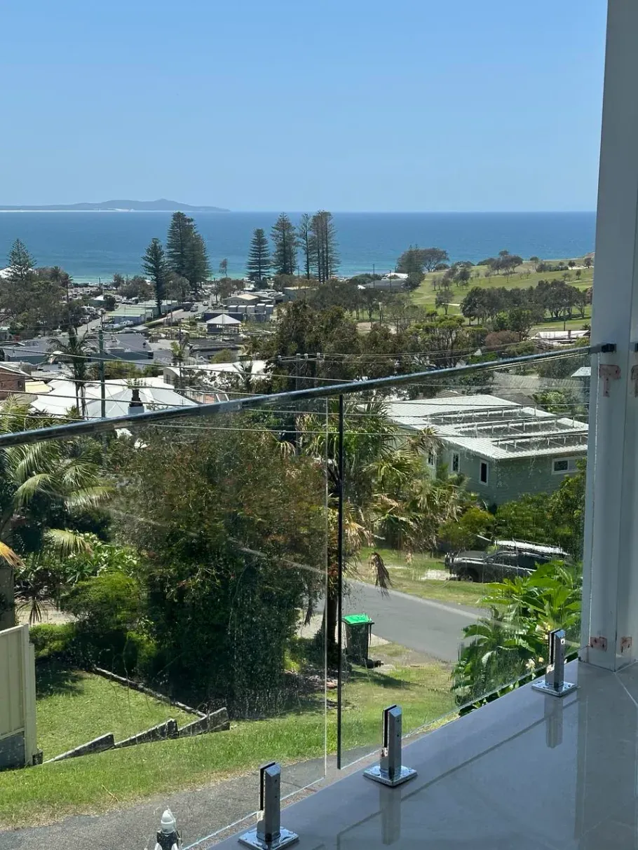 A Balcony With A View Of The Ocean And A CITY — Mid Coast Glass Fencing In Port Macquarie, NSW