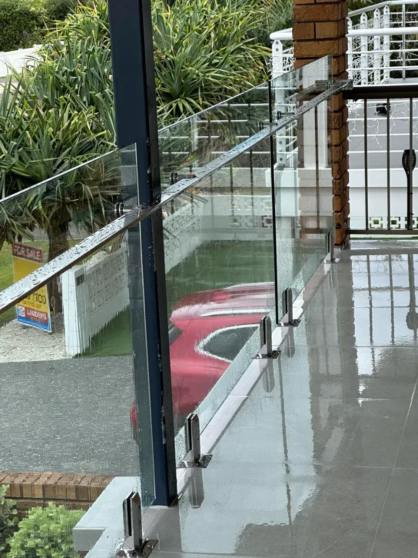 A Balcony With A Glass Railing And A Red Car Parked In The BackgroUND — Mid Coast Glass Fencing In Forster, NSW