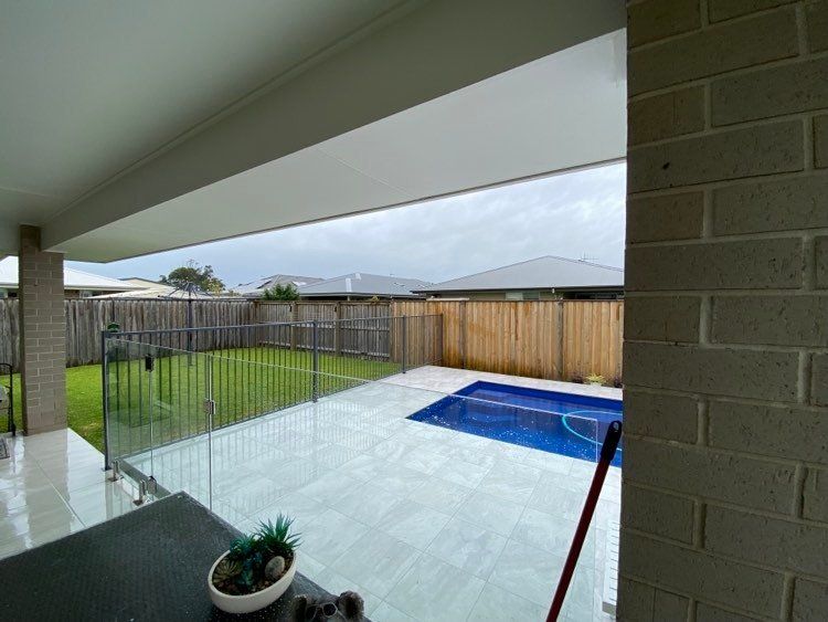 Modern Swimming Pool Covered With Glass And Aluminium Fence — Mid Coast Glass Fencing In Old Bar, NSW