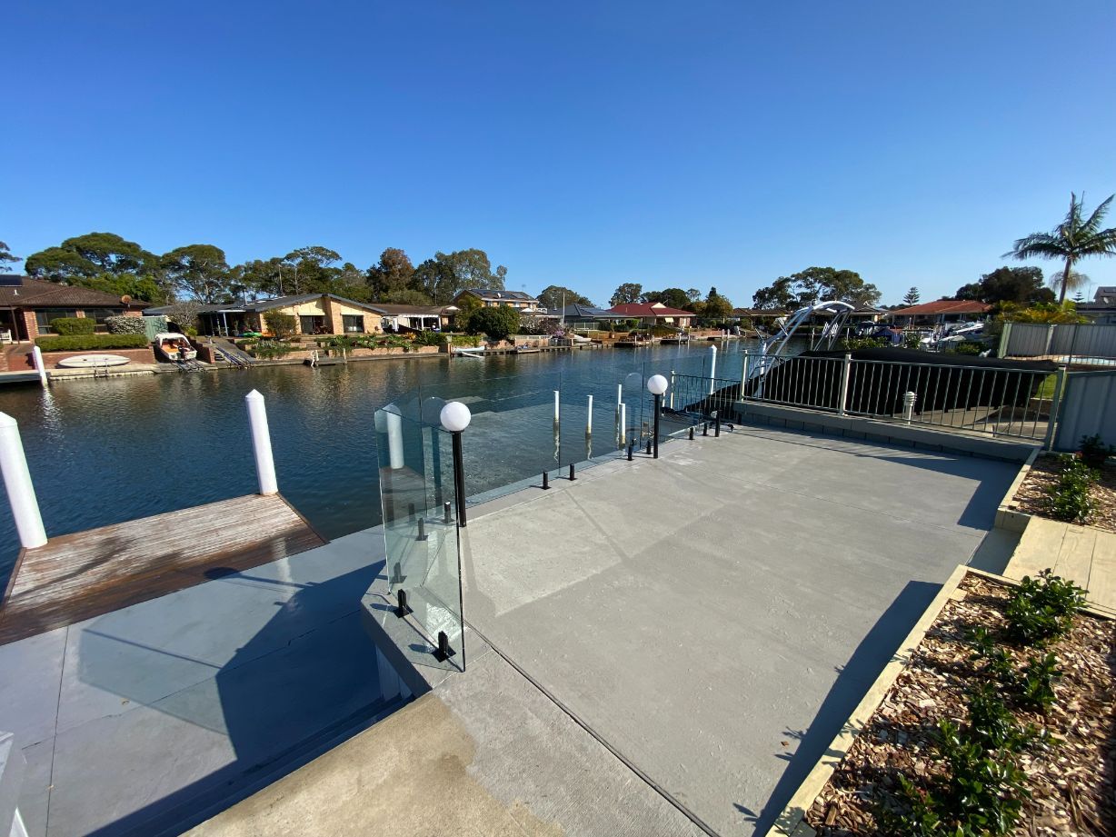 Frameless Glass Fencing With Black Stainless Spigots — Mid Coast Glass Fencing In Old Bar, NSW