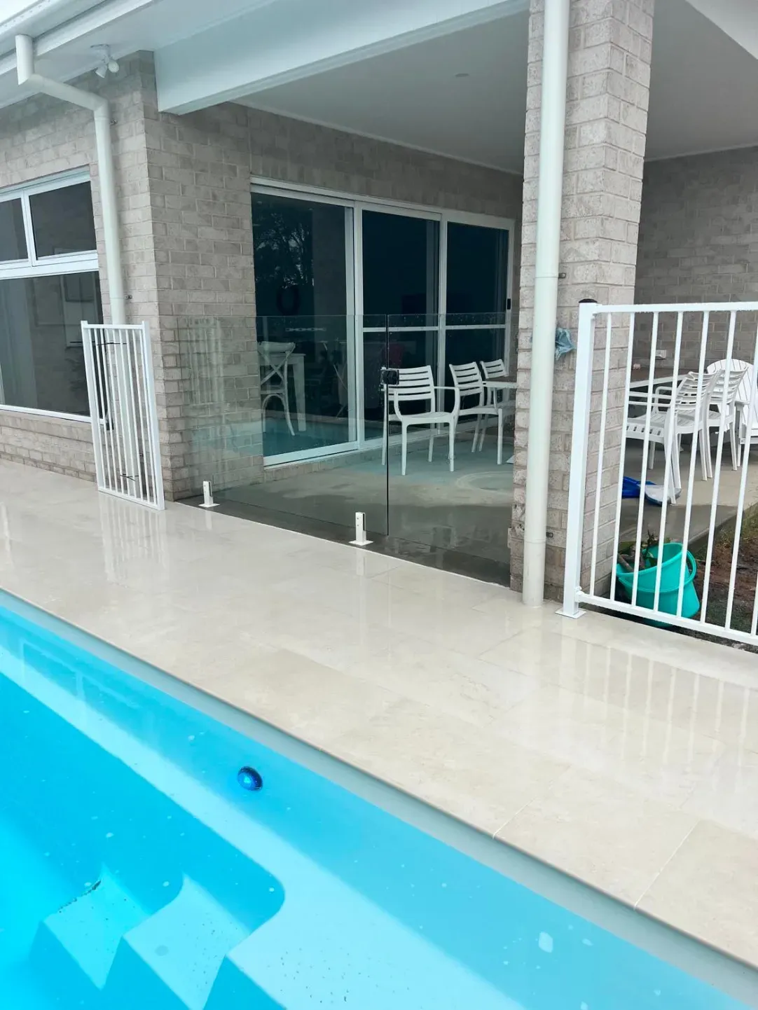 A Swimming Pool With A Glass Fence And Stairs Leading To IT — Mid Coast Glass Fencing In Wauchope, NSW