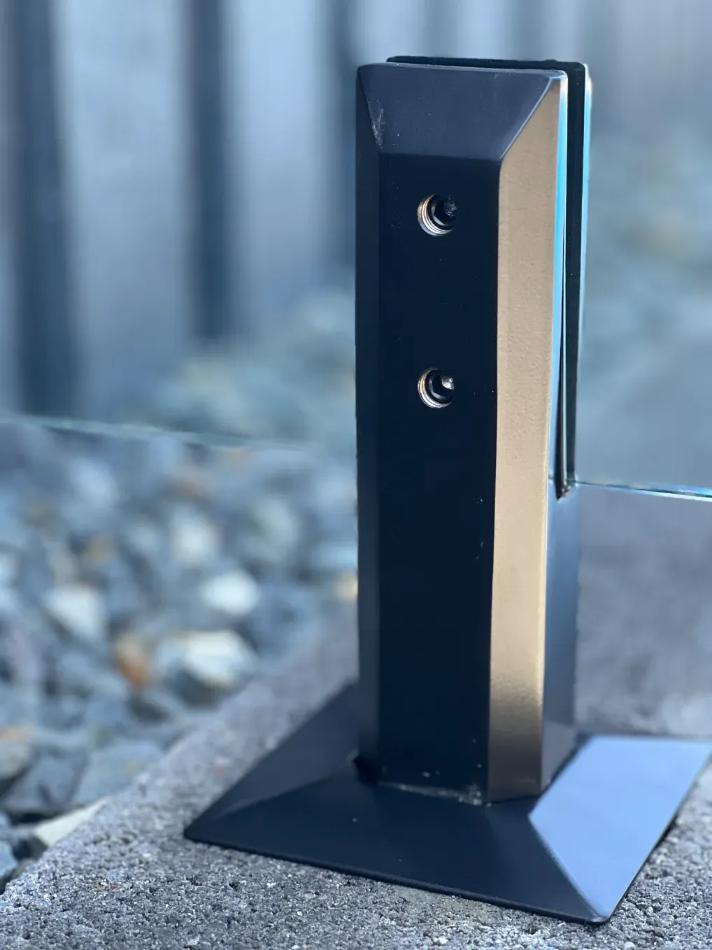 A Black Metal Pole Is Sitting On Top Of A Glass TaBLE — Mid Coast Glass Fencing In Port Macquarie, NSW