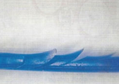 A blue wave is breaking on a white surface.