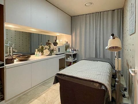 A room with a bed and a sink in it.