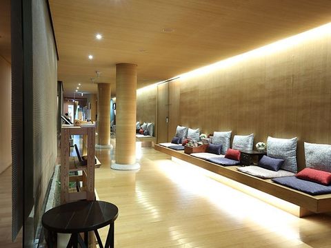 A long hallway with a row of benches and pillows