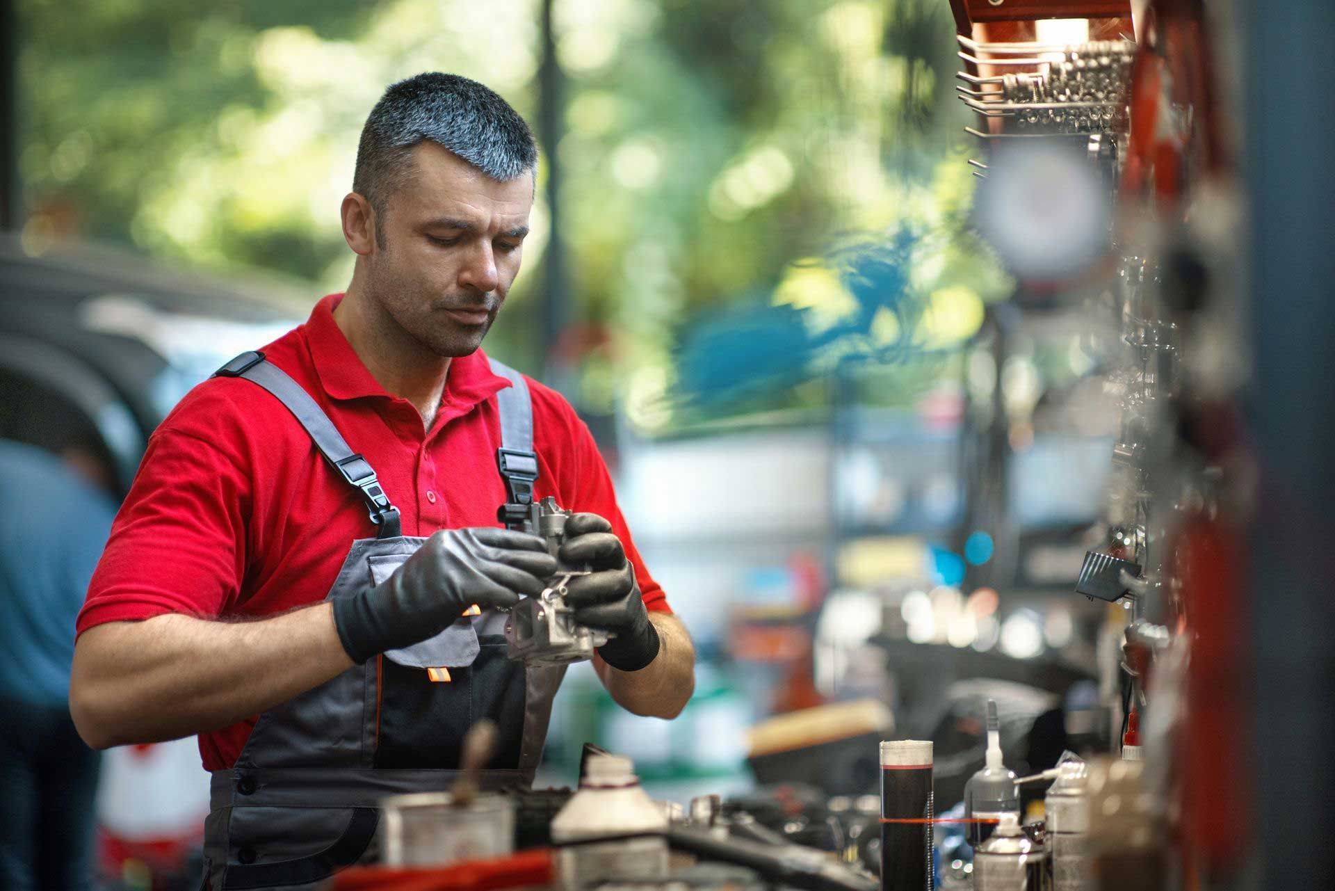 Car mechanic performing maintenance procedure. Car mechanic performing maintenance procedure.