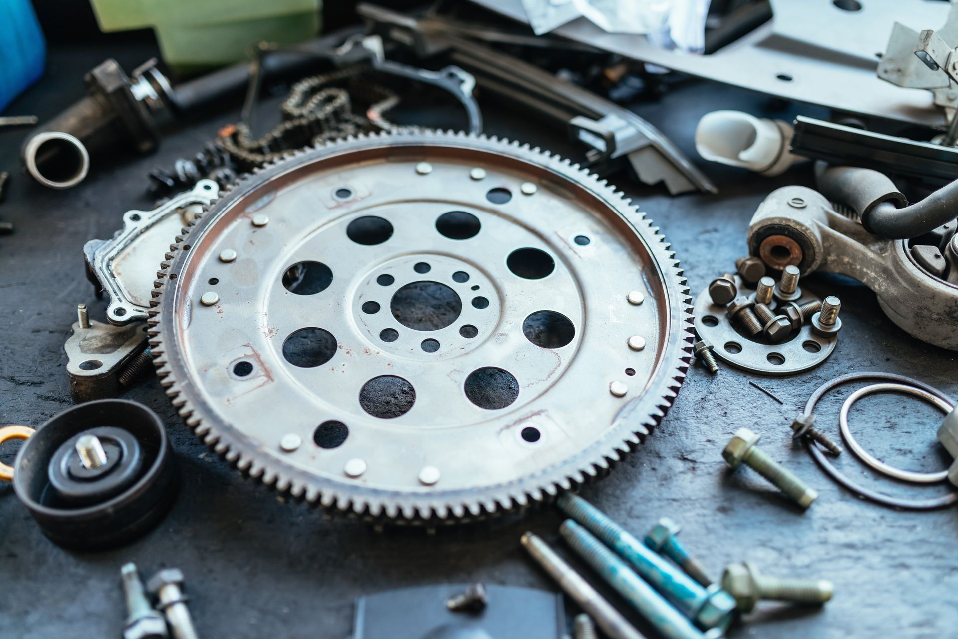 Mechanic tools & spare parts in a car repair shop. Selective focus on car parts.
