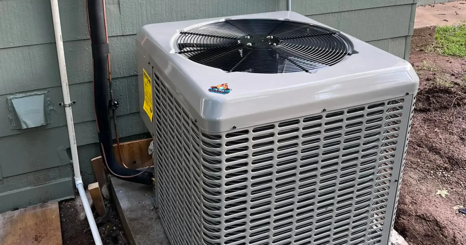 Air Fair Heat and Air LLC - A large air conditioner is sitting outside of a house.